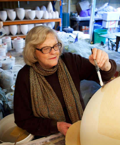 Pippin Drysdale working on a vessel in the spray booth at her Fremantle studio
