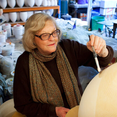 Pippin Drysdale working on a vessel in the spray booth at her Fremantle studio